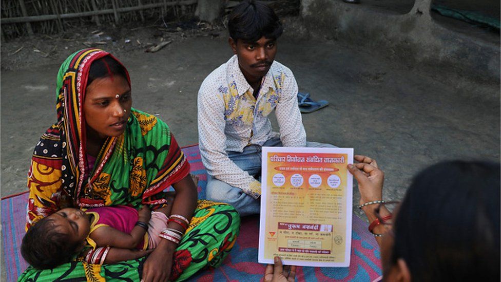 RANIGANJ, BIHAR, INDIA-NOVEMBER 15, 2017: An Accredited Social Health Activist (ASHA) discusses family planning options with a young couple