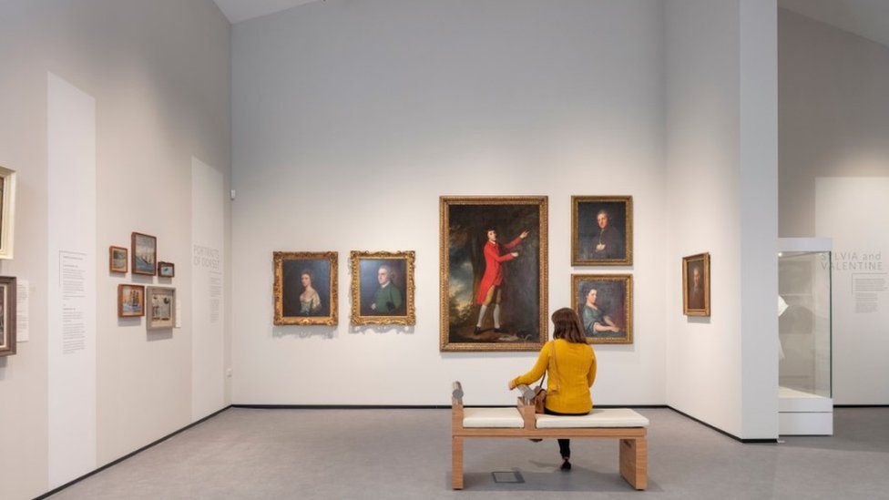Woman sitting on a bench in Dorset Museum art gallery