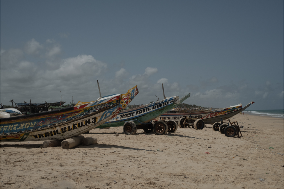 Pirogues lined up on the beach in Fass Boye. Large pirogues are used for migration voyages.