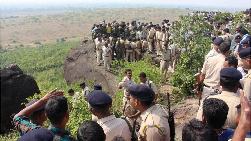 Indian police and bystanders gather at the site where eight SIMI activists, who escaped from Central Jail in Bhopal, were killed by Special Task Force police at the hillocks of Acharpura village, near the capital Bhopal on October 31, 2016