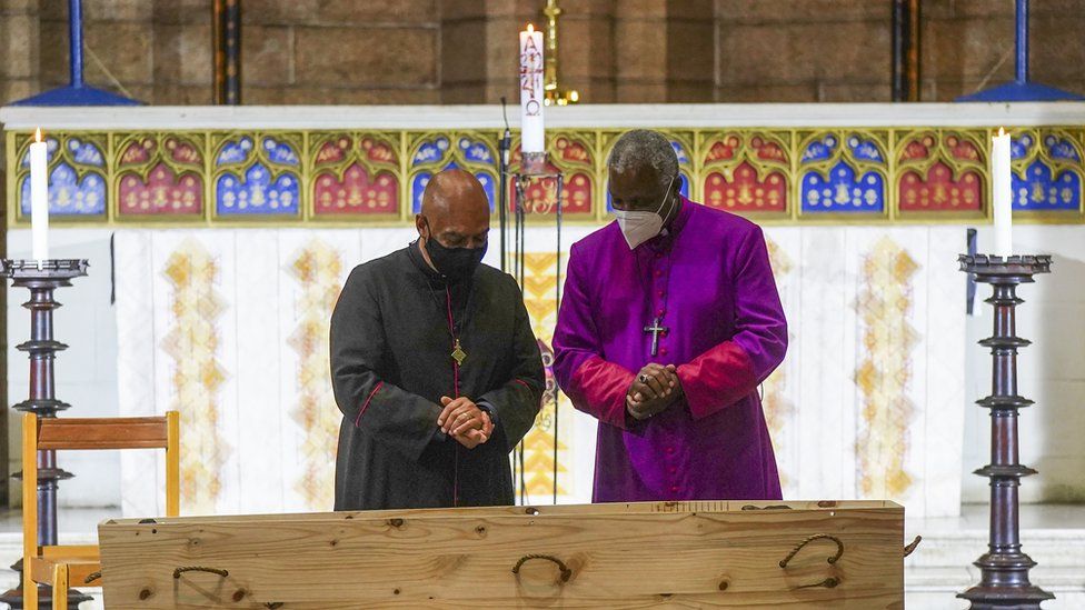 The Dean of St George's Cathedral Michael Weeder (L) and Archbishop of Cape Town Thabo Makgoba (R) stand near the coffin of late Archbishop Emeritus Desmond Tutu in St George's Cathedral in Cape Town, South Africa, 30 December 2021