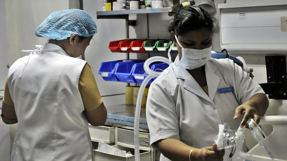 Indian nurses work in a ward at a government hospital in New Delhi