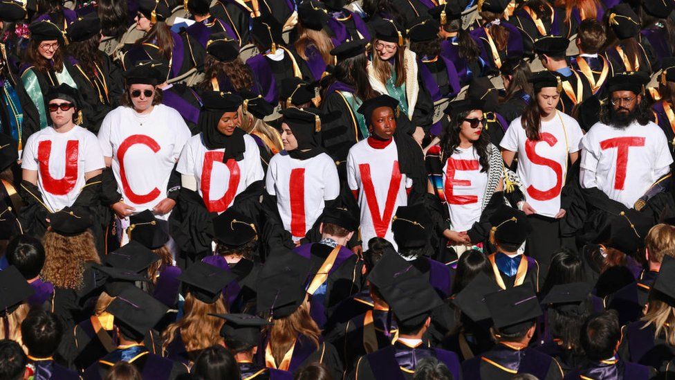 UC Berkeley Law School graduates wear t-shirts that read "UC DIVEST" as a form of protest during the UC Berkeley Law School commencemen