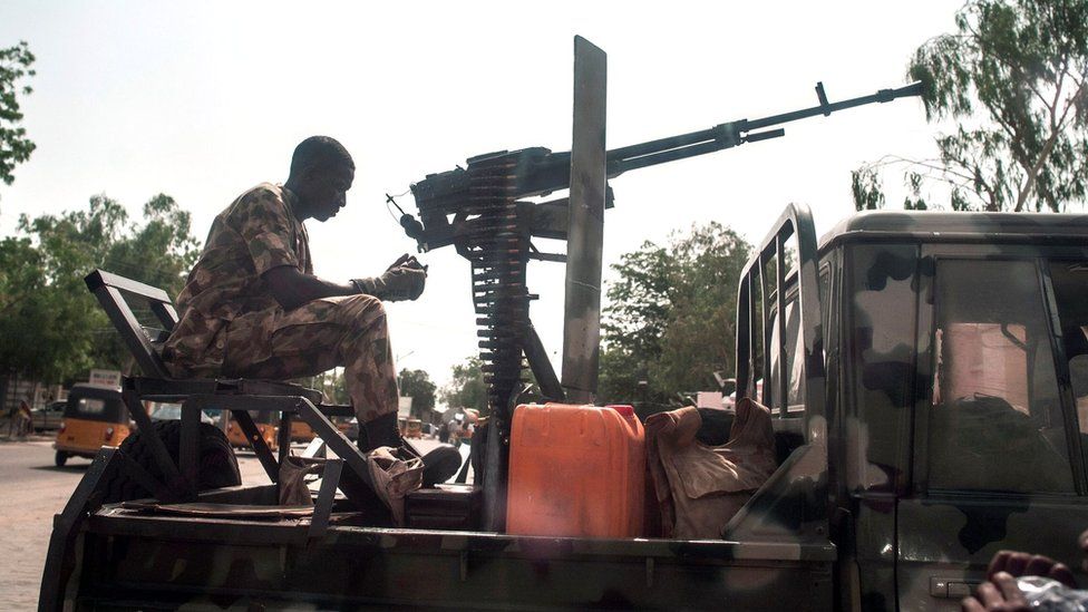 A soldier sits on the back of an armed vehicle in Maiduguri in north-eastern Nigeria on July 7, 2017