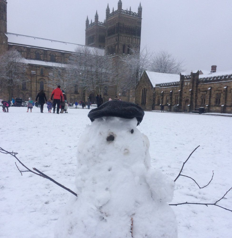 A snowman in front of Durham Cathedral