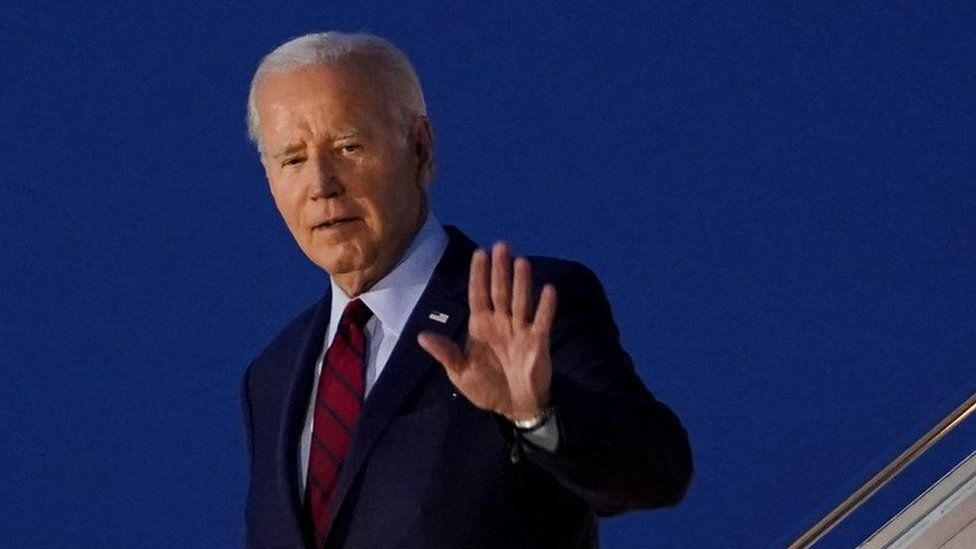 Joe Biden walks down the steps of Air Force One