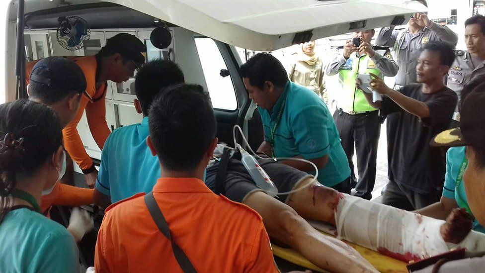Injured person receives medical care after an explosion on a tourist boat off Bali, Indonesia, on 15 September