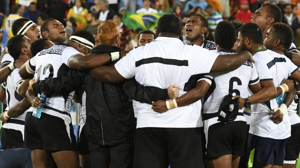 Fiji players sing after winning the rugby sevens