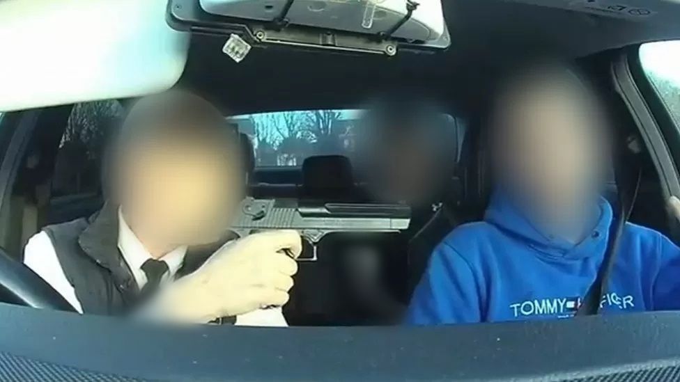 Man holding gun in taxi