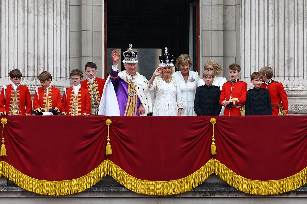 King Charles and Queen Camilla stand on the Buckingham Palace balcony following their coronation ceremony