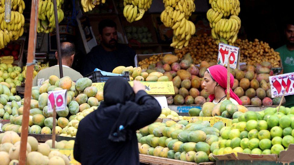 A woman shops at a market in Cairo, Egypt (9 October 2023)