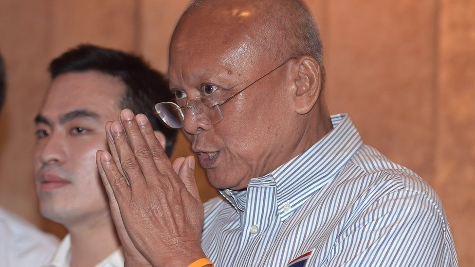 Suthep Thaugsuban, a key leader of anti-government street protests that led to the May 2014 military takeover, gives a traditional greeting to the media during a press conference in Bangkok on July 30, 2015