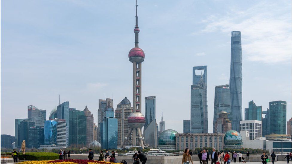Tourists visit the Lujiazui complex across the Huangpu River on the Bund in Shanghai, China,