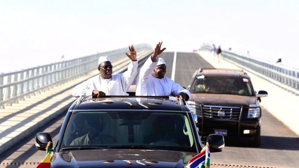 Senegal's President Macky Sall (L) and Gambia's President Adama Barrow (R) wave as they inaugurate a bridge in Farafenni