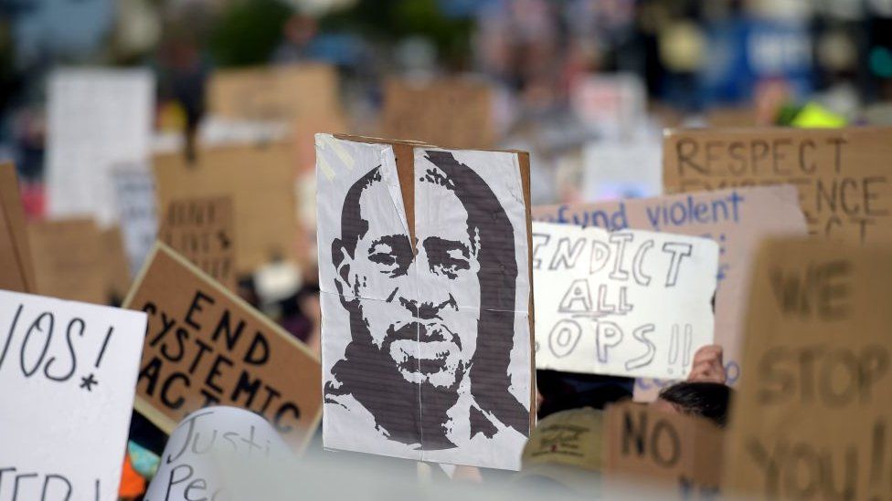 Protesters march holding placards and a portrait of George Floyd during a demonstration against racism and police brutality, in Hollywood, California on June 7, 2020
