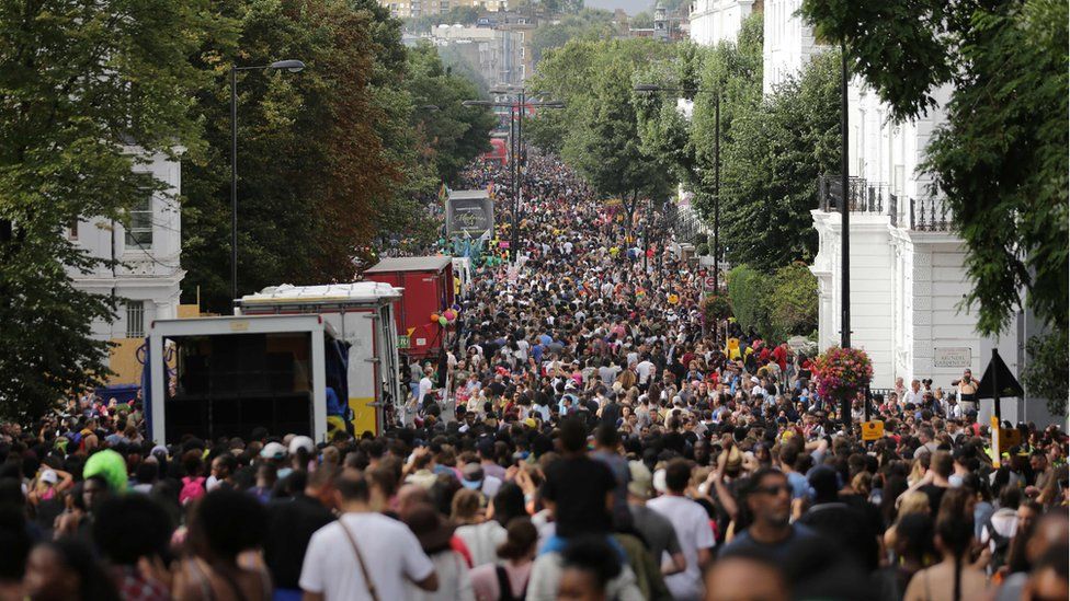 Revellers line the streets on the first day of the Notting Hill Carnival