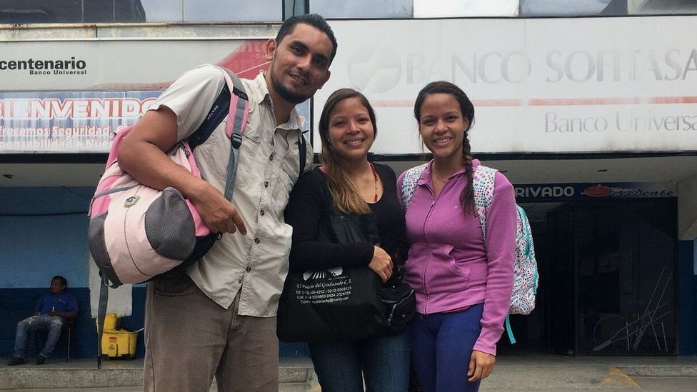 Victor, Claudia and Coraima pose at a bus station in Venezuela