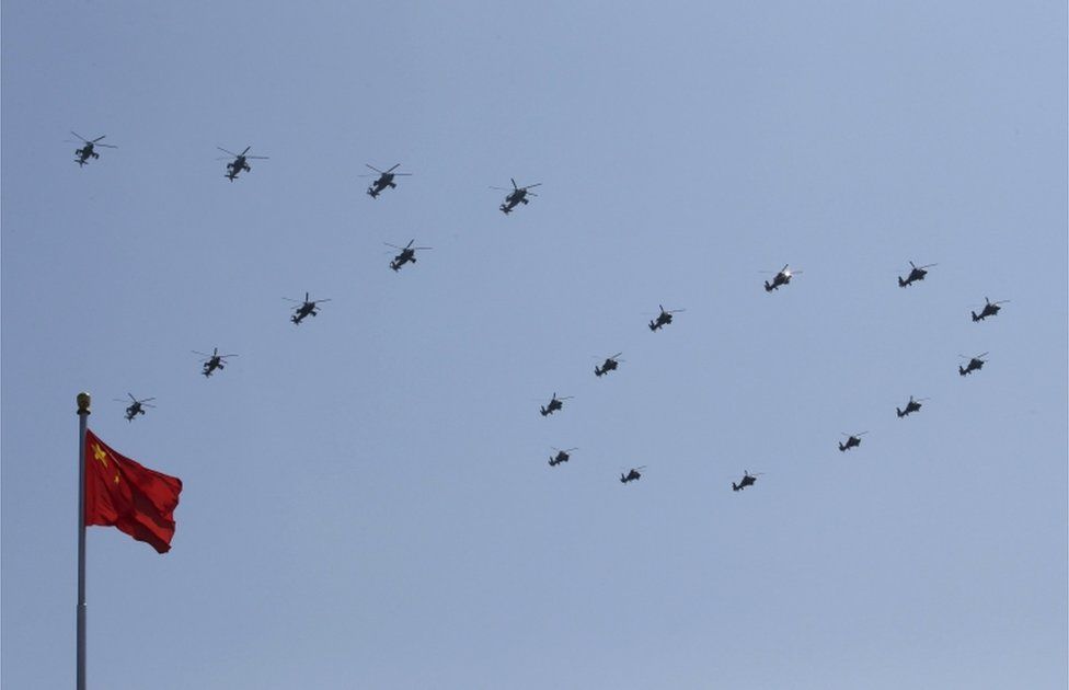 Military helicopters form the number "70" above a Chinese national flag as they perform during the military parade to mark the 70th anniversary of the end of World War Two, in Beijing, China, 3 September 2015