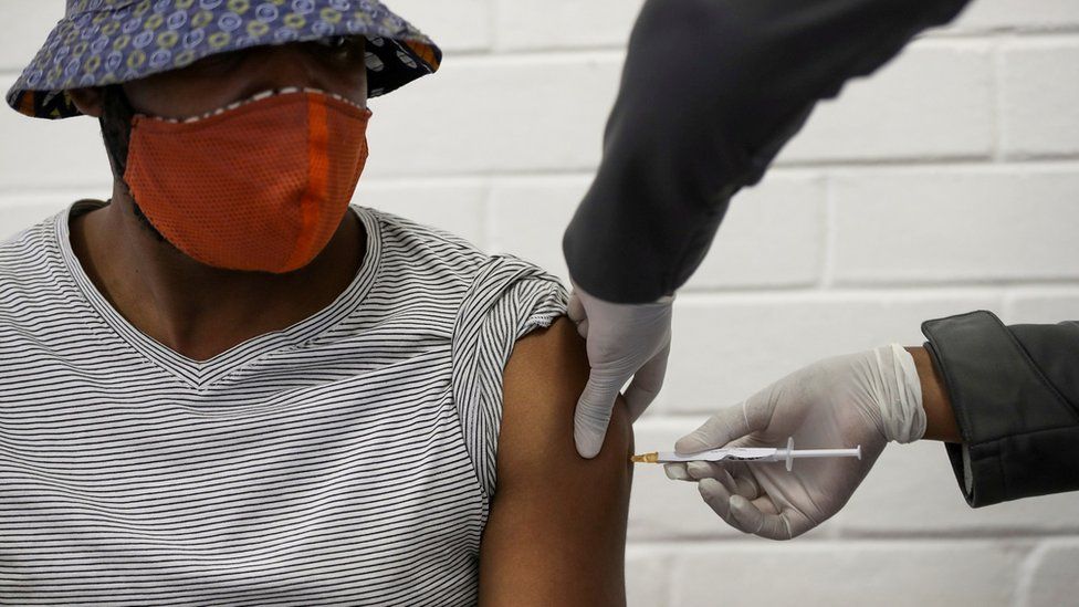 A volunteer receives an injection from a medical worker during the country"s first human clinical trial for a potential vaccine against the novel coronavirus, at Baragwanath Hospital in Soweto, South Africa, June 24, 2020. REUTERS/Siphiwe Sibeko/File Photo