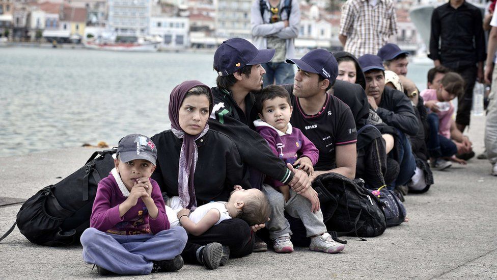 Newly arrived migrants wait their turn to be registered near the port of Mytilene, on the Lesbos island, on June 18, 2015.
