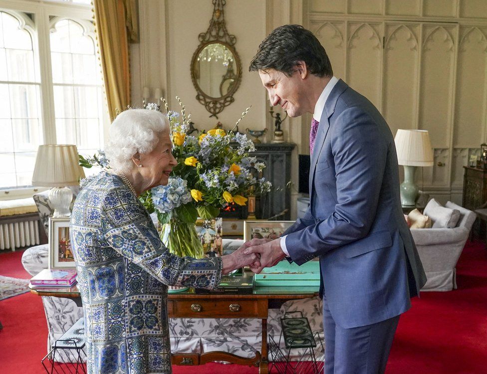 Britain's Queen Elizabeth II shakes hands with Canadian Prime Minister Justin Trudeau as they meet for an audience at the Windsor Castle, Berkshire, on 7 March 2022
