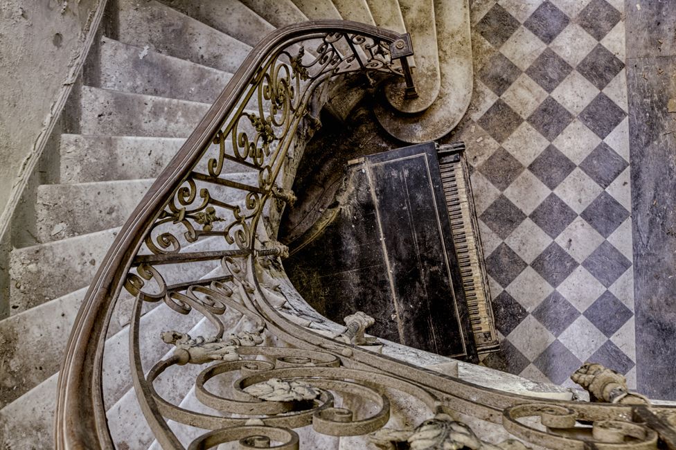 Abandoned staircase with piano
