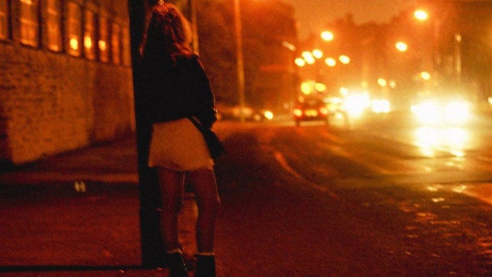 Unidentified sex worker standing on a street corner