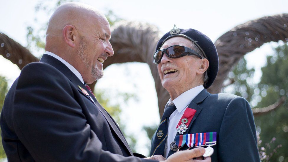 D-Day veteran Alfred Barlow (right), 96, who lost his medals at a motorway service station, is presented with replacements by fellow blind veteran Alan Walker