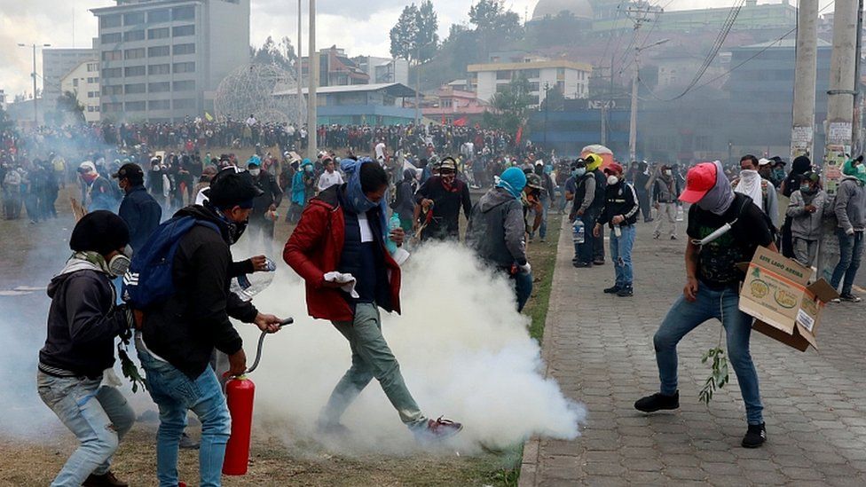 A demonstrator kicks a tear gas canister during a protest against Ecuador's President Lenin Moreno's austerity measures in Quito, Ecuador October 12, 2019
