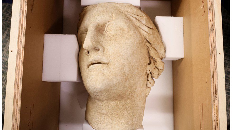 The marble head of goddess Athena in a wooden box