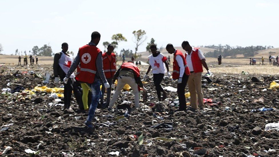 Red cross team work amid debris at the crash site of Ethiopia Airlines