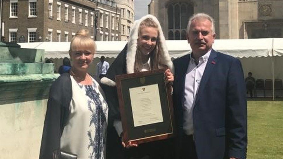 Kateryna with her parents Vira and Oleksandr at her graduation from Cambridge University