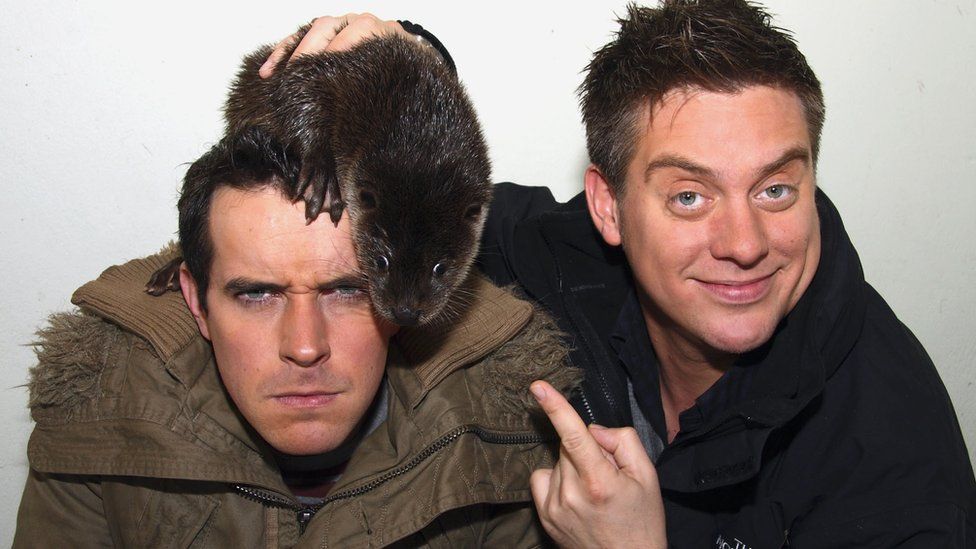 Dick and Dom with an animal on his head