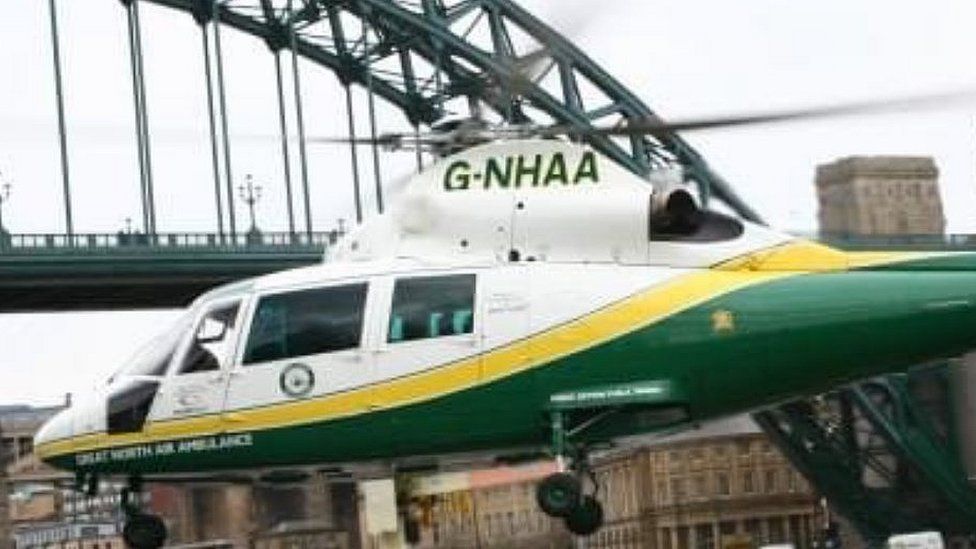 Great North Air Ambulance lands in Newcastle with Tyne bridge beyond