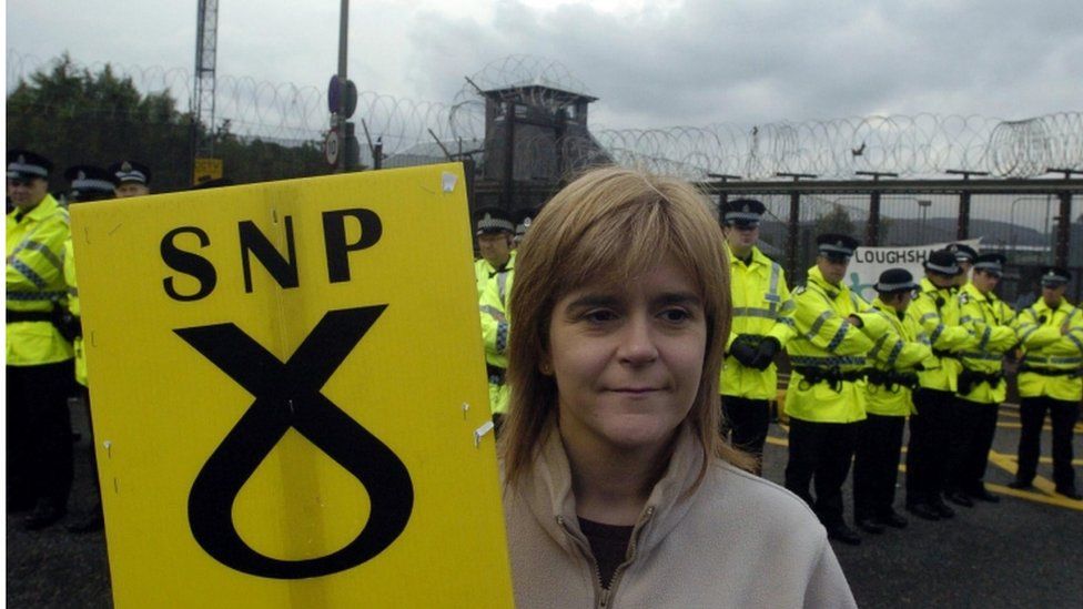 Nicola Sturgeon, MSP with a placard during an anti-nuclear campaign attempt to blockade the Faslane nuclear submarine base on the Clyde, Scotland