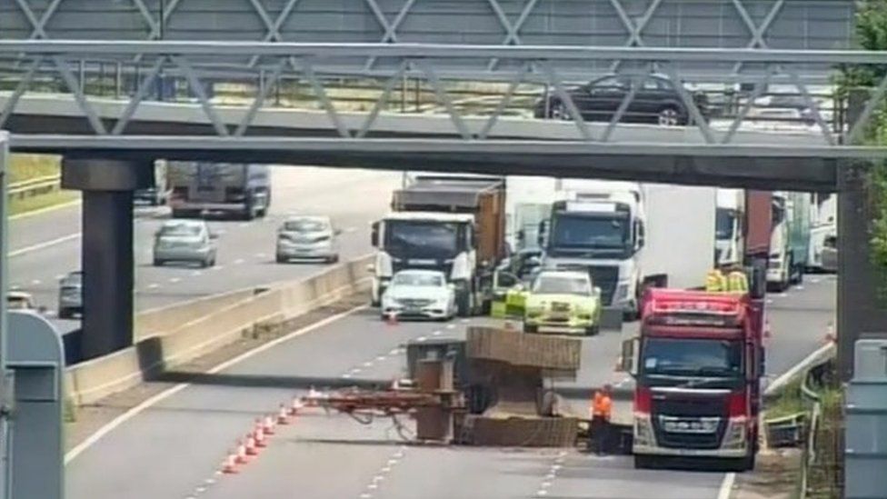 M6 shut as lorry carrying machinery hits bridge BBC News