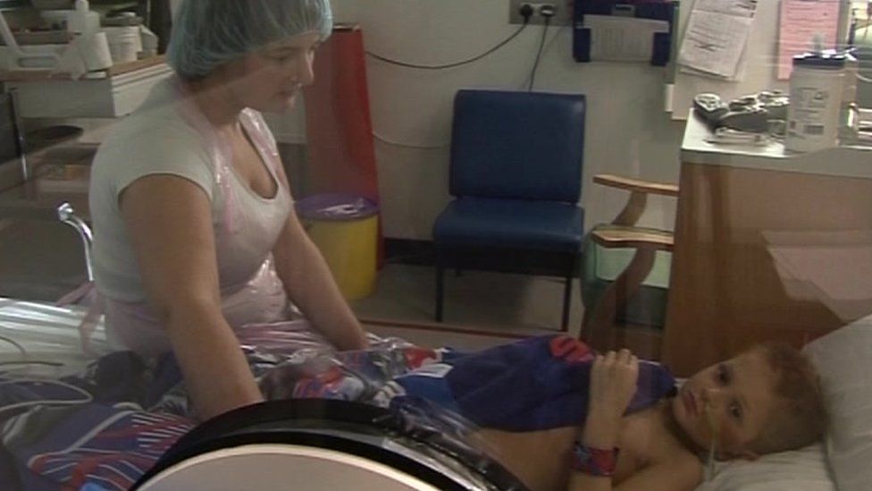 Rhys Harris being treated in hospital as a child