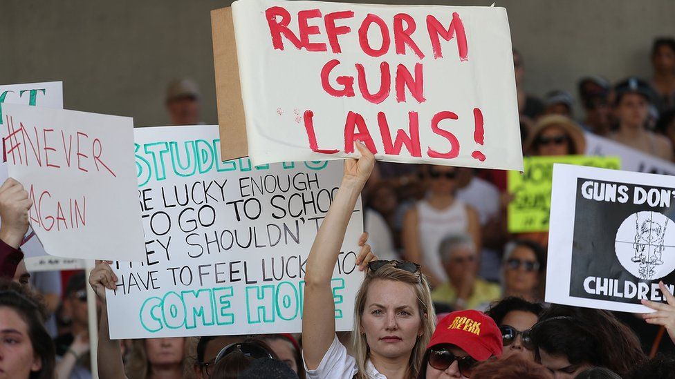 People join together after a school shooting that killed 17 to protest against guns on the steps of the Broward County Federal courthouse on 17 February 2018 in Fort Lauderdale, Florida.