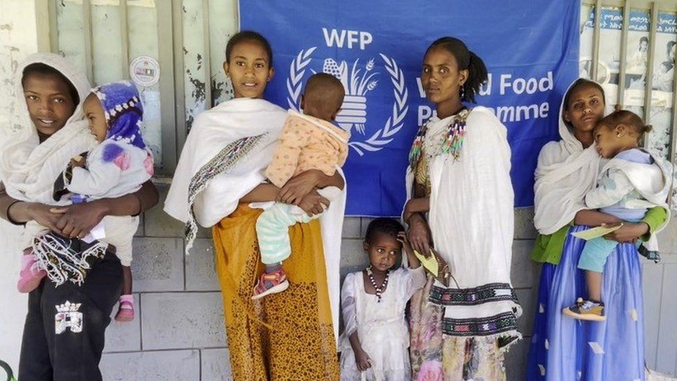 Women wait to receive nutrition supplements from WFP to treat their malnourished children at a locally run health post at Kuha, 15km southwest of Mekelle, in the Tigray region on 10 December 2022