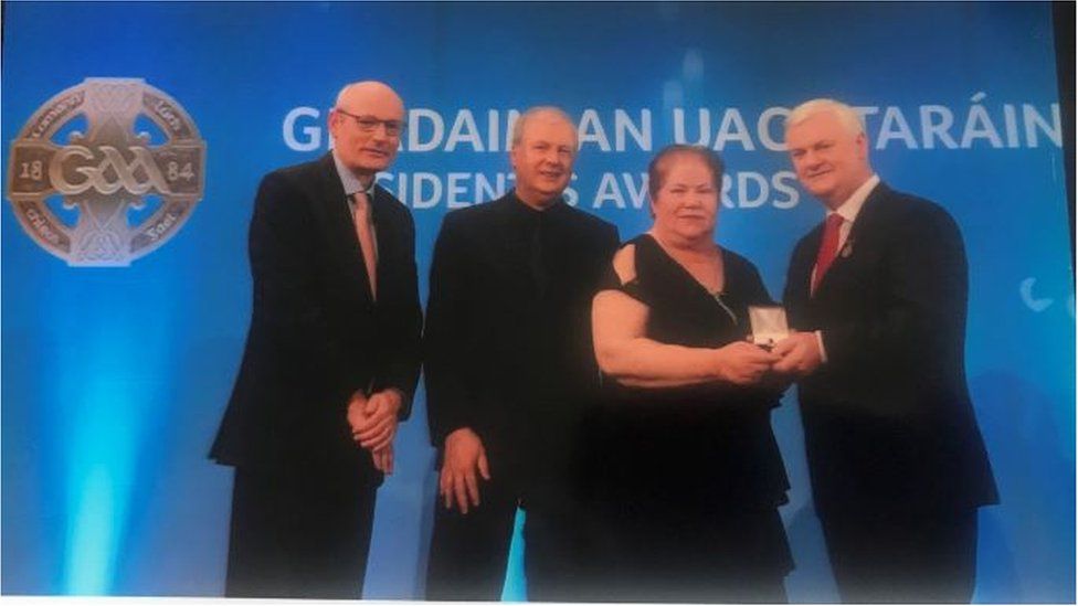 Margaret Keane receiving the GAA President's Award from Aogán O' Fearghail, former Ulster GAA President, in 2017