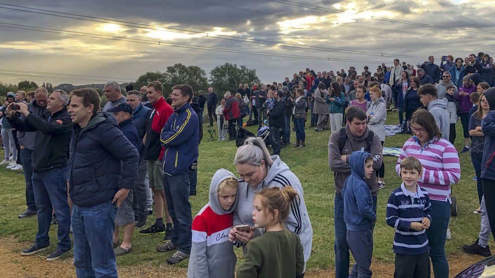 Crowds gather to watch the cooling towers being demolished
