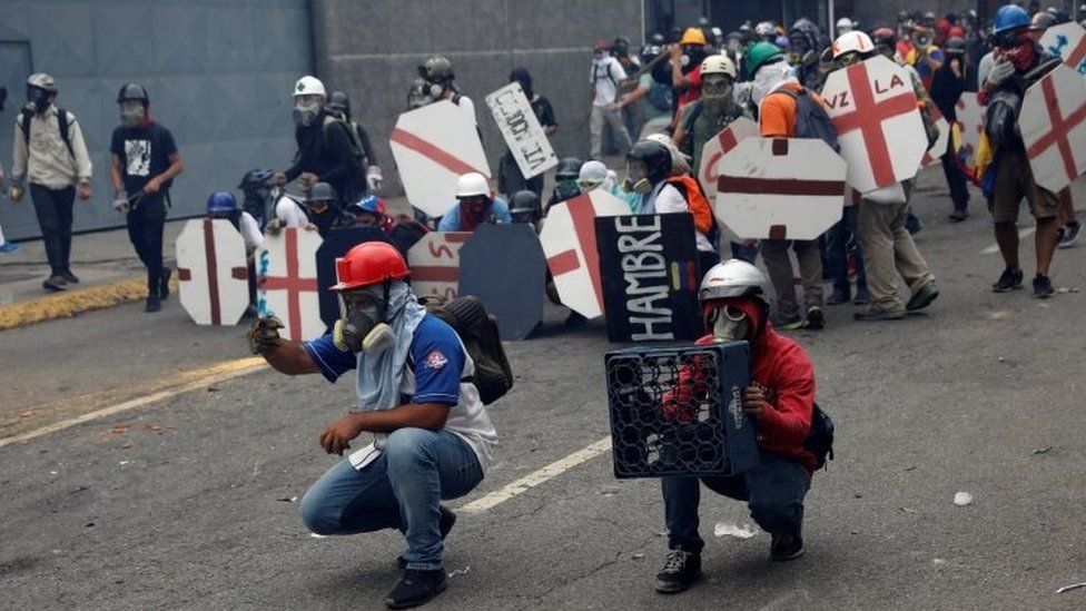Opposition supporters clash with riot police during a rally against President Nicolas Maduro in Caracas (3 May)