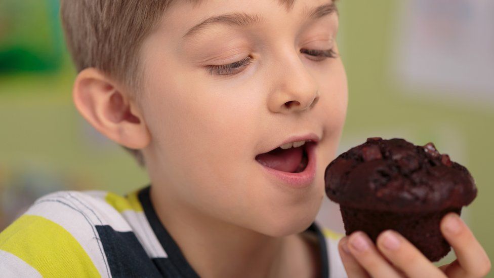 Boys eating a chocolate muffin