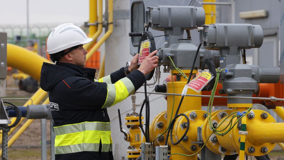 Worker stands among pipes at a compressor station of the new Baltic Pipe pipeline