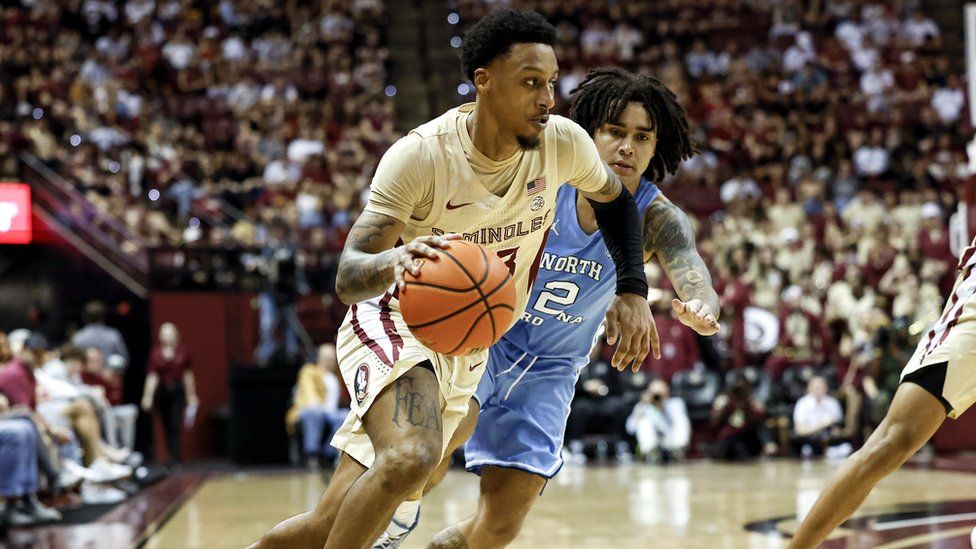 Primo Spears #23 of the Florida State Seminoles is defended by Elliot Cadeau #2 of the North Carolina Tar Heels.
