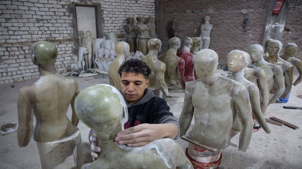 Egyptian workers making mannequins.