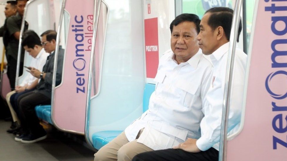 Prabowo and Widodo talk on a train
