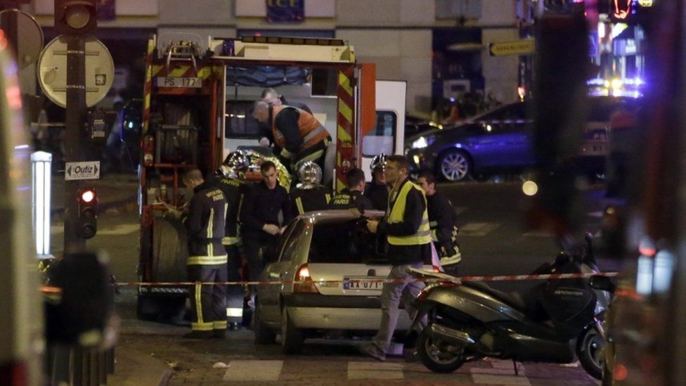 Ambulance workers are seen at the scene in the 10th arrondissement of the French capital Paris