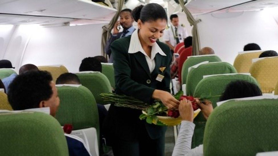 Passengers are welcomed by cabin crew inside an Ethiopian Airlines flight who departed from the Bole International Airport in Addis Ababa, Ethiopia, to Eritrea"s capital Asmara on July 18, 2018
