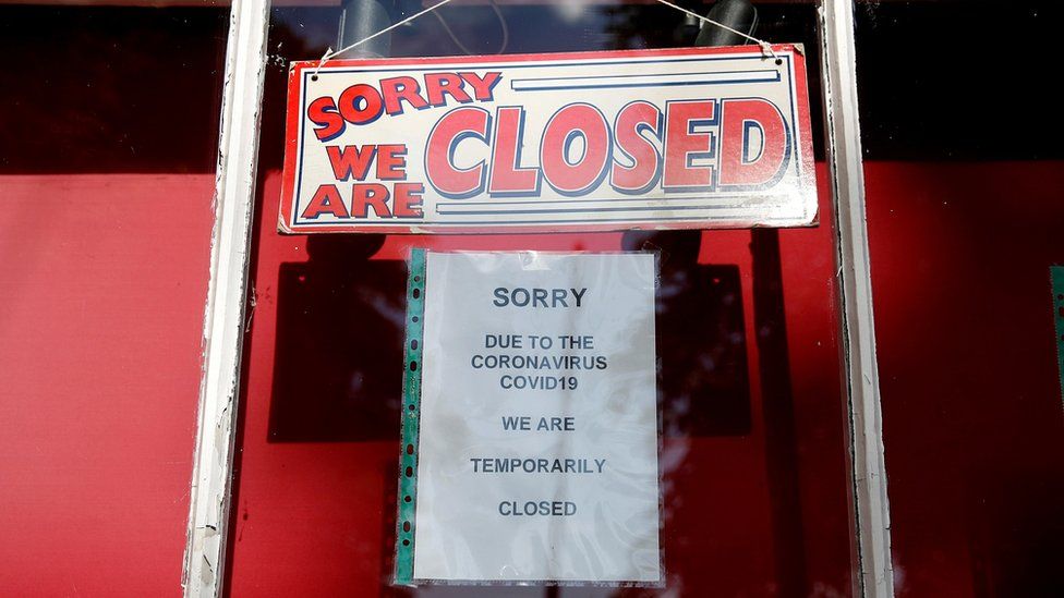 File image of a shop displaying a "closed" sign